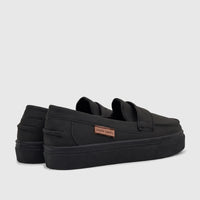 Pair of black Pierre Cardin boys casual slip-on shoes with platform soles, viewed from a rear-side angle on a white