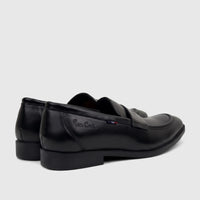 Black Pierre Cardin Boys Youth dress slip-on shoes, seen from a rear-side angle, showcasing the brand logo on the side.