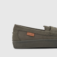 Close-up of an olive green Pierre Cardin boys' youth casual slip-on shoe with a textured surface and prominent logo.