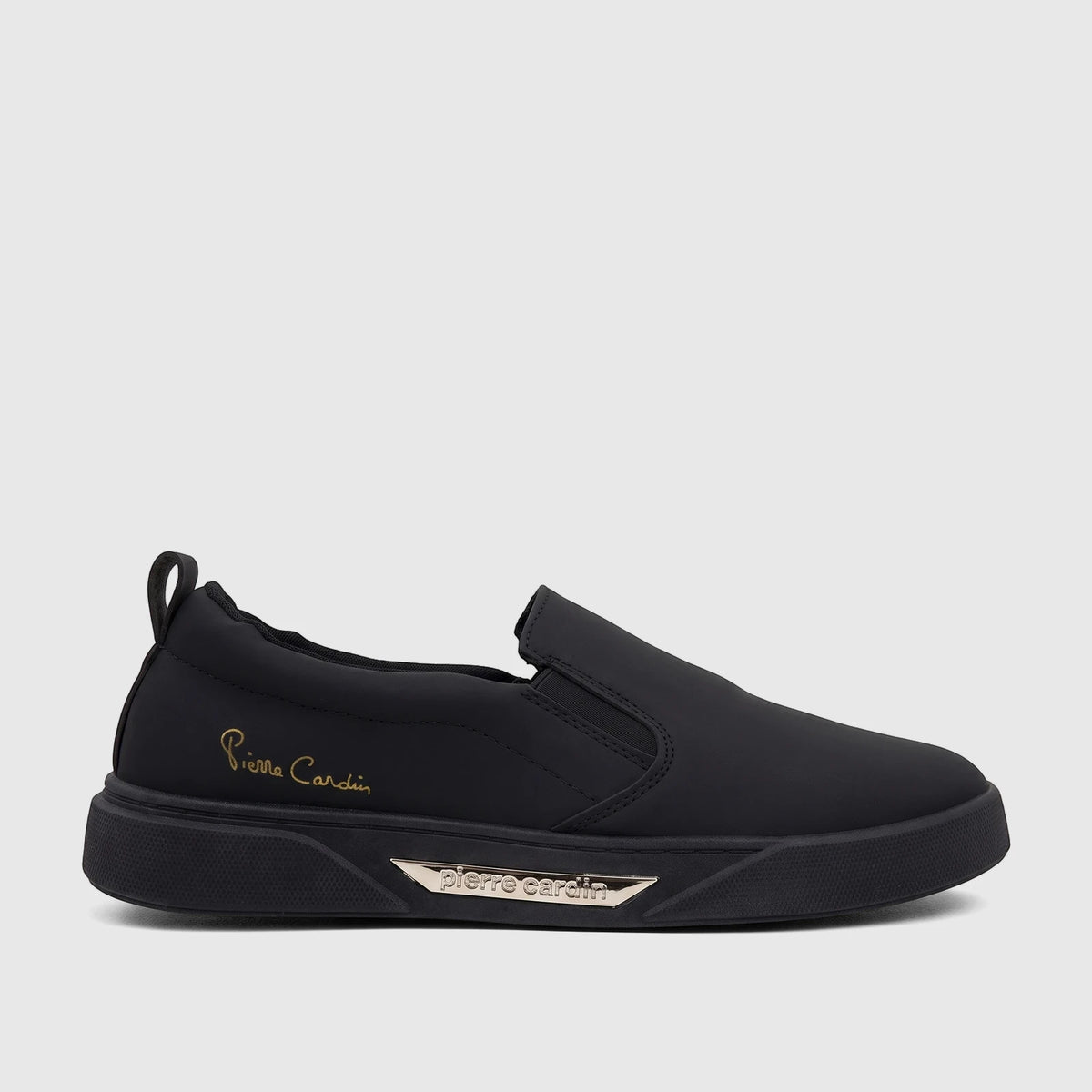 Black Pierre Cardin ladies' casual slip-on sneaker with a gold logo, shown in a side profile view.