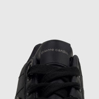 Close-up view of a black Pierre Cardin casual sneaker (PCL11006) showing the laces and the brand logo on the tongue.