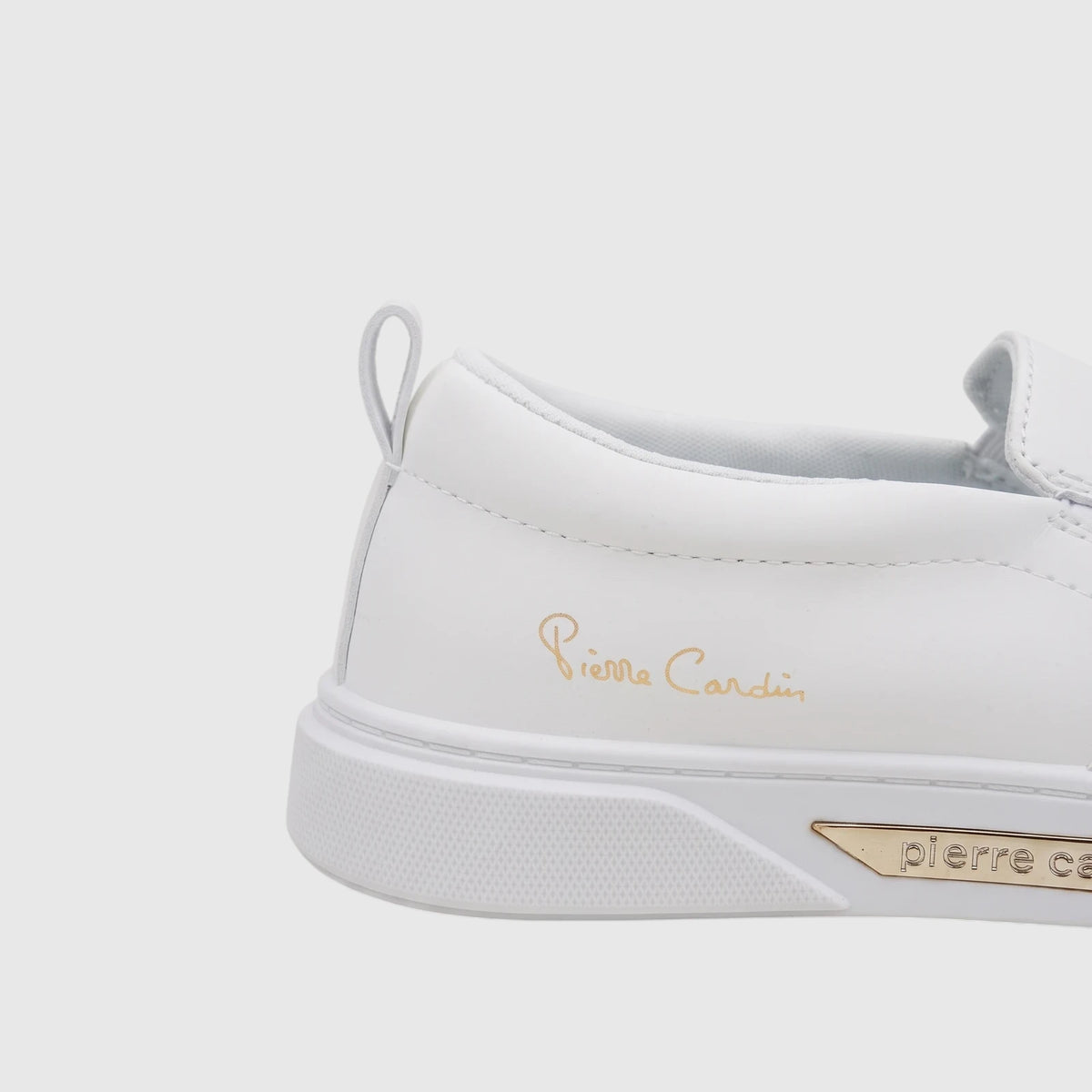 Pierre Cardin PC Ladies white casual slip-on sneaker with gold logo, low-cut silhouette and padded collar.
