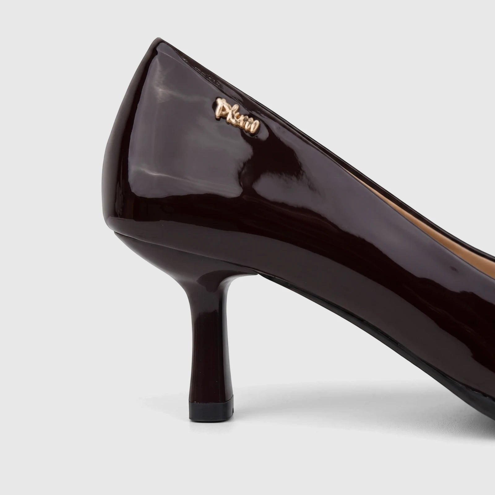 Close-up side view of a Plum Ladies Dress Court Cameron PL970004 pump in dark chocolate patent leather with a high heel.