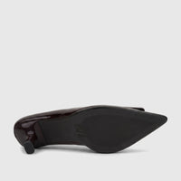 Plum patent leather ladies' dress court shoe, showing the textured sole and low block heel from a side view.