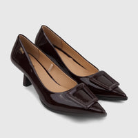 Plum patent leather dress court shoes with pointed toes and rectangular buckle detail, styled for elegant wear.