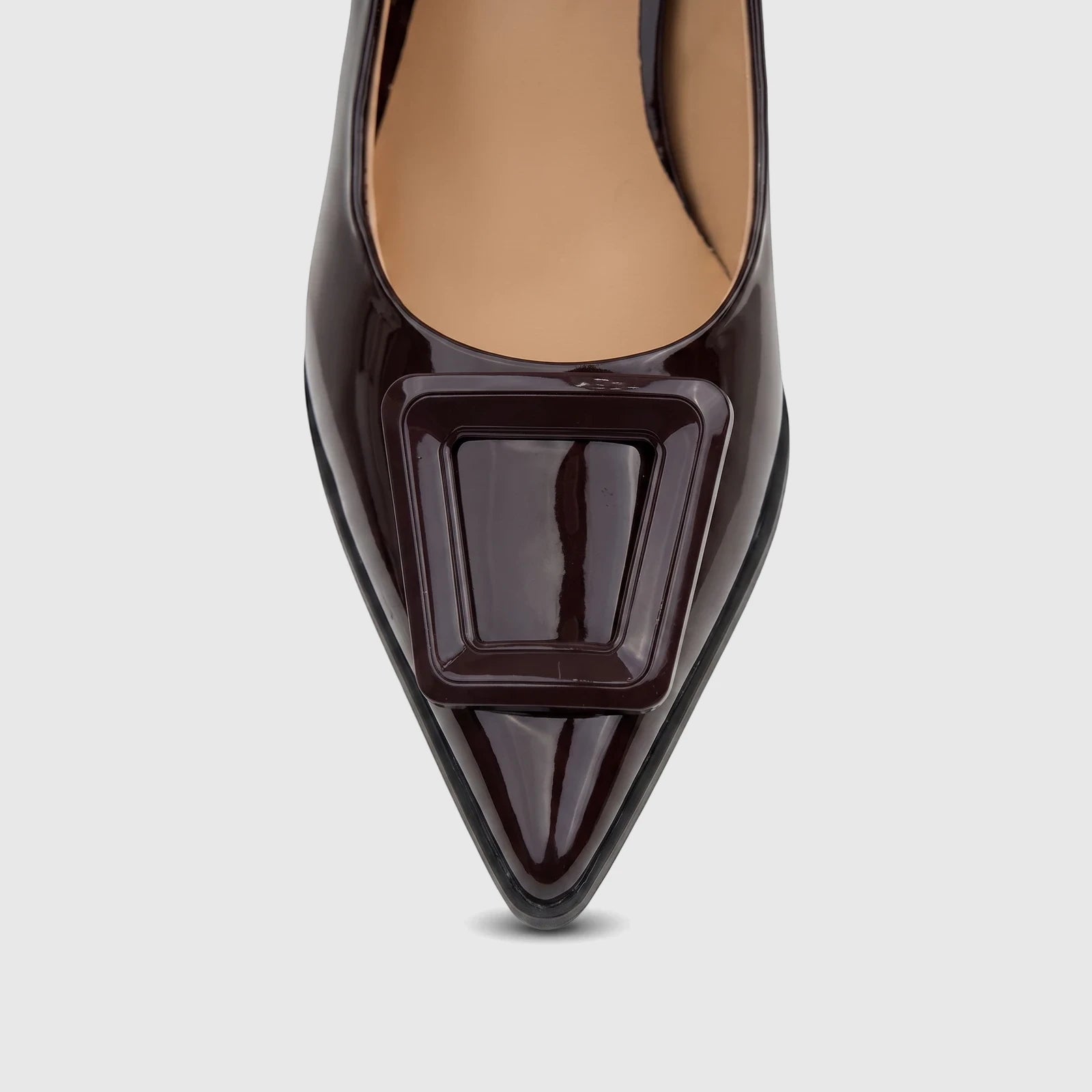 Plum patent leather dress pump with a sleek pointed toe and prominent rectangular buckle detail.