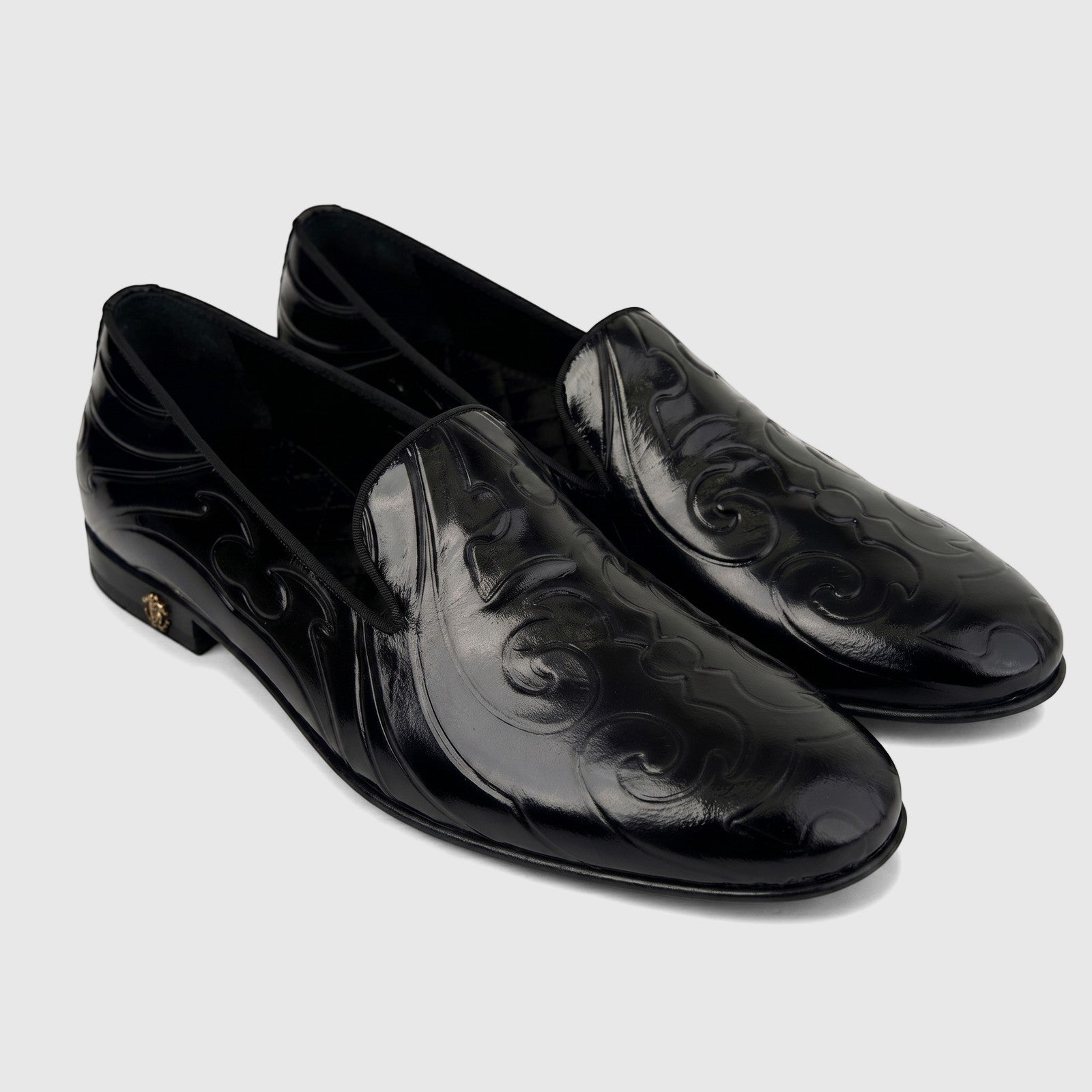 Pair of Roberto Cavalli Men's Black Leather Dress Loafers, featuring an embossed pattern and a gold-tone heel logo.
