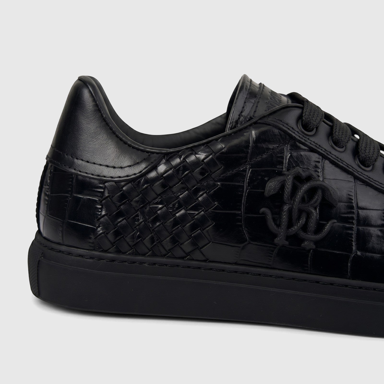 Close-up angled view of a Roberto Cavalli Men's Leather Sneaker 30720 in black, featuring woven and crocodile-textured