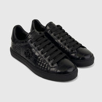 Pair of black Roberto Cavalli men's low-top leather sneakers with woven and crocodile-embossed textures.