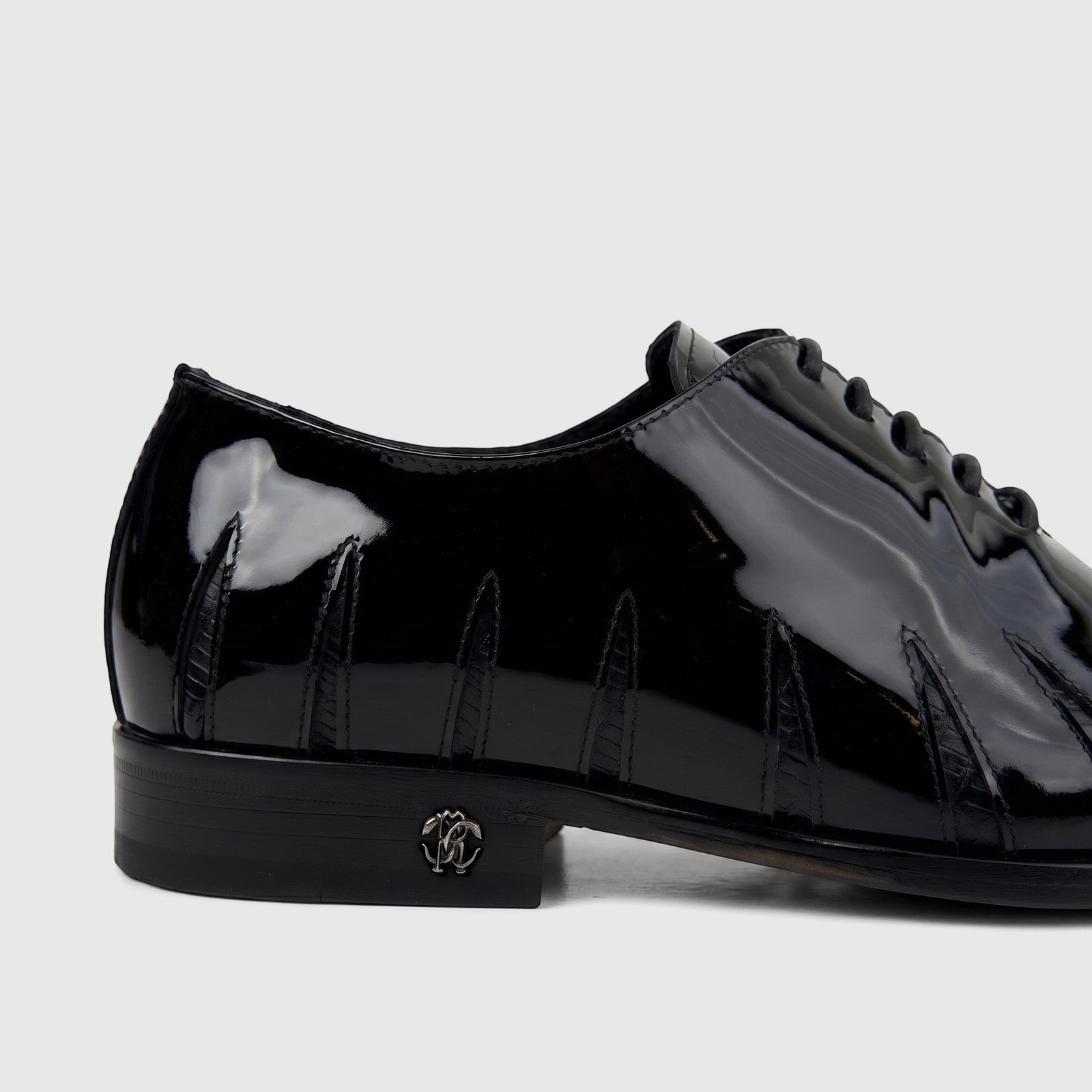 Roberto Cavalli men's black patent leather dress oxford shoe with distinctive stitching and RC logo emblem.