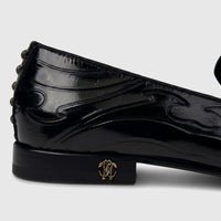 Roberto Cavalli men's black patent leather dress loafer with gold RC logo and studded heel, side view.