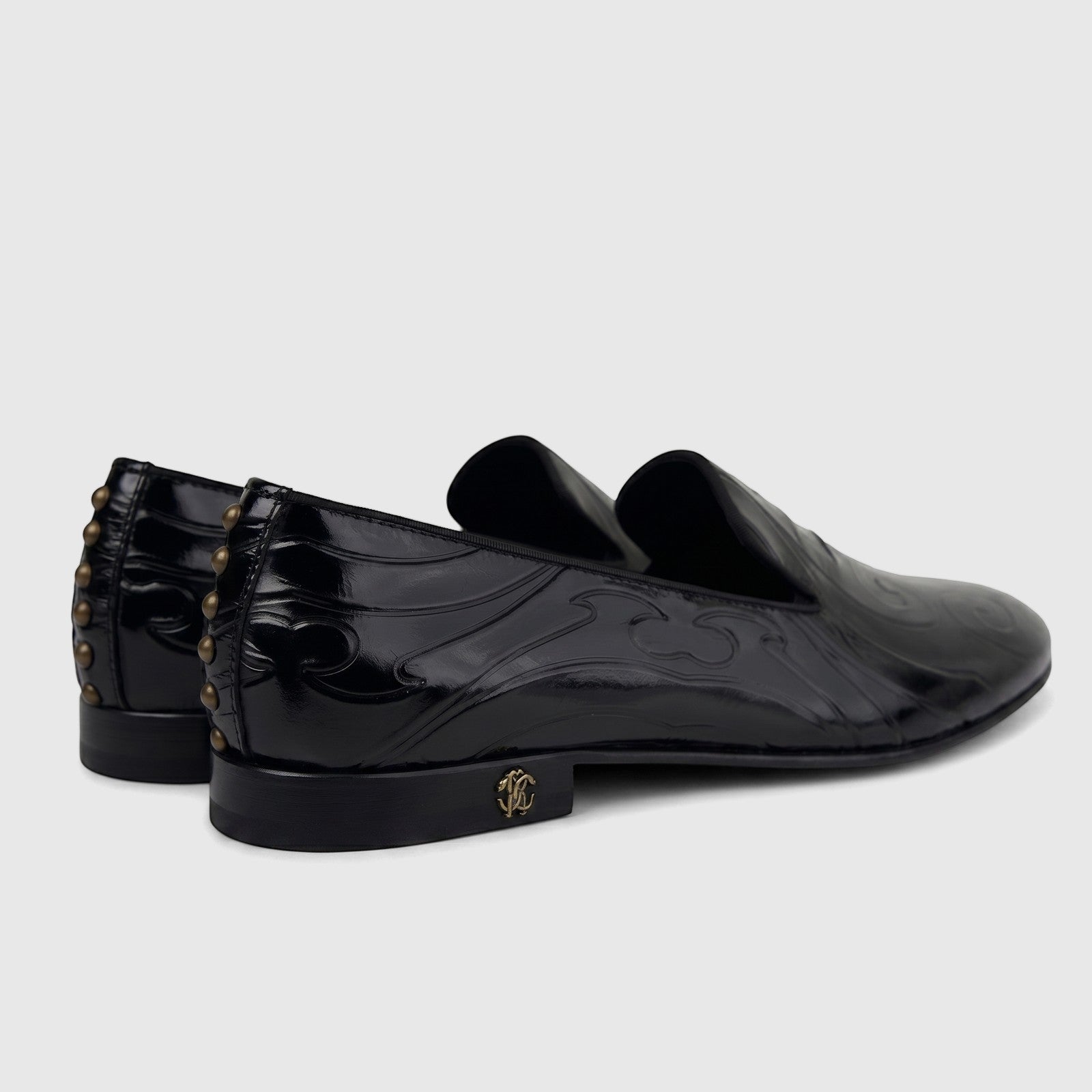 Roberto Cavalli Men's Leather Dress Loafer 30703. Black patent leather shoes with an embossed pattern and gold studded heels.