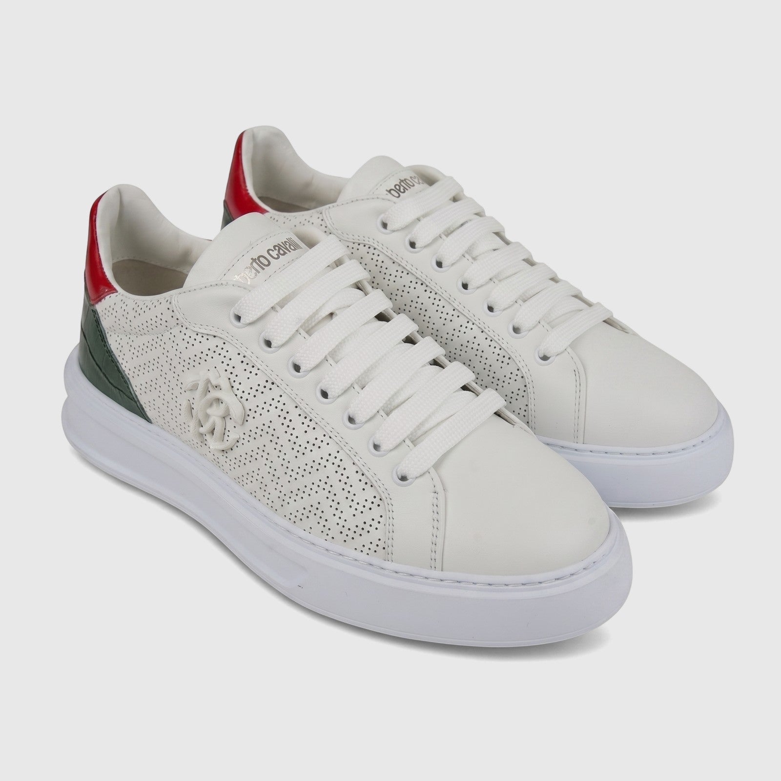 White Roberto Cavalli men's leather sneakers with red and dark green heel accents and perforated detailing, viewed at an