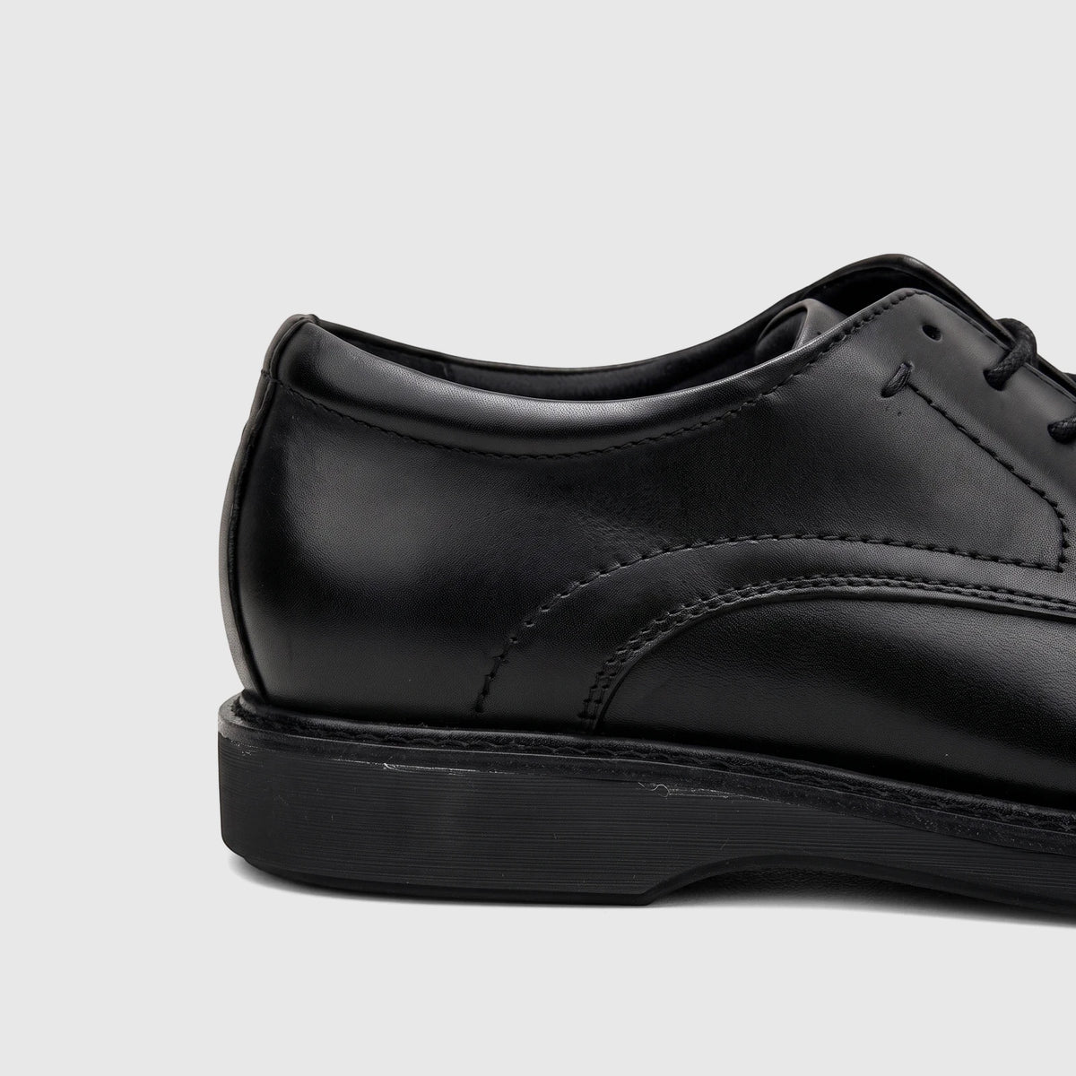 Close-up of a black leather Rockport Men's Dress/Comfort Lace Up Leonard shoe, showing the side and heel.