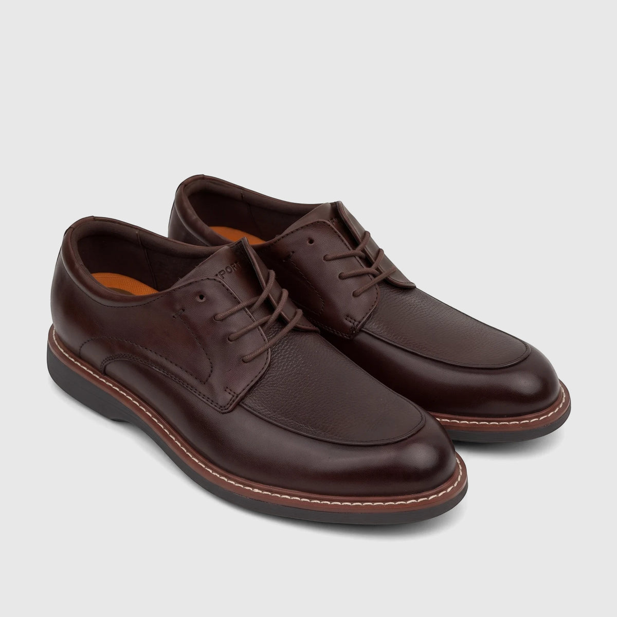 A pair of Rockport Men's Dress/Comfort Lace Up Leonard shoes in dark brown leather with white stitching detail, displayed