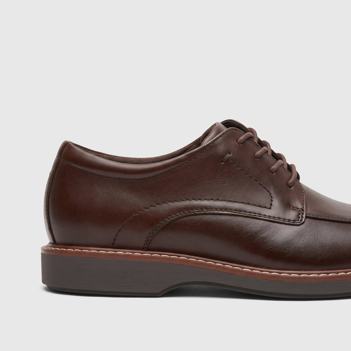 Side view of a Rockport Men's Dress/Comfort Lace Up Leonard shoe in dark brown leather.