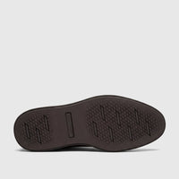 Bottom view of a Rockport men's dress comfort shoe sole in dark brown with a diamond pattern grip and embossed logo.