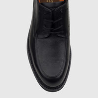 Black Rockport men's lace-up dress shoe with smooth and textured leather, seen from a top-down perspective on a white