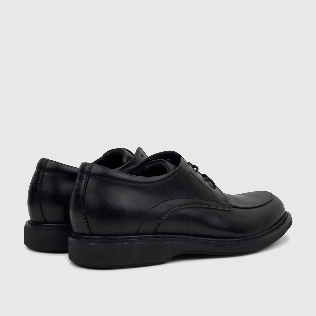 Rockport Men's Leonard lace-up dress shoes in black leather, showing the rear and side profile on a white background.