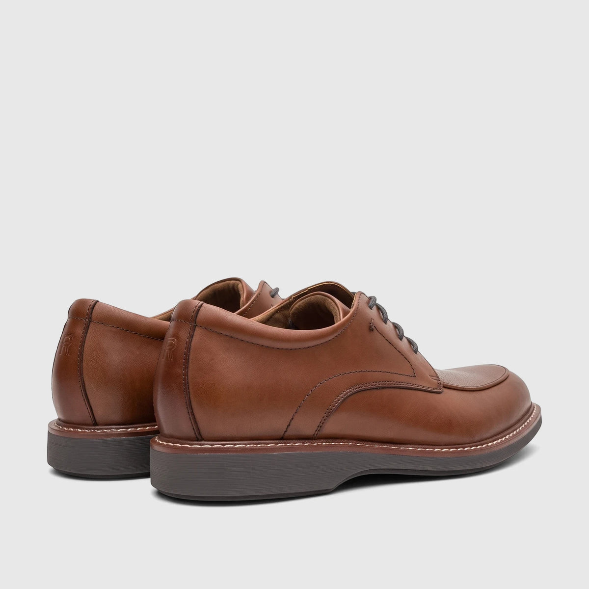 Brown leather Rockport Men's Leonard dress/comfort lace-up shoes, shown from a rear-side angle on a white background.