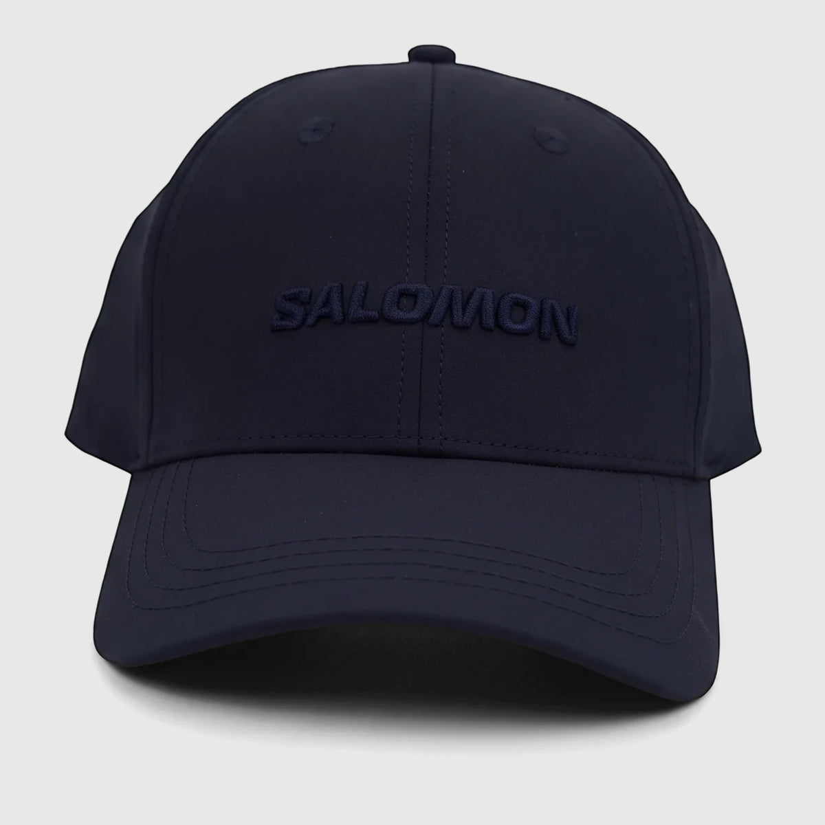 Front view of a navy blue Salomon adjustable cap, featuring the 'SALOMON' logo embroidered prominently on the front.