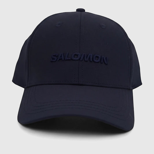 Front view of a navy blue Salomon adjustable cap, featuring the 'SALOMON' logo embroidered prominently on the front.