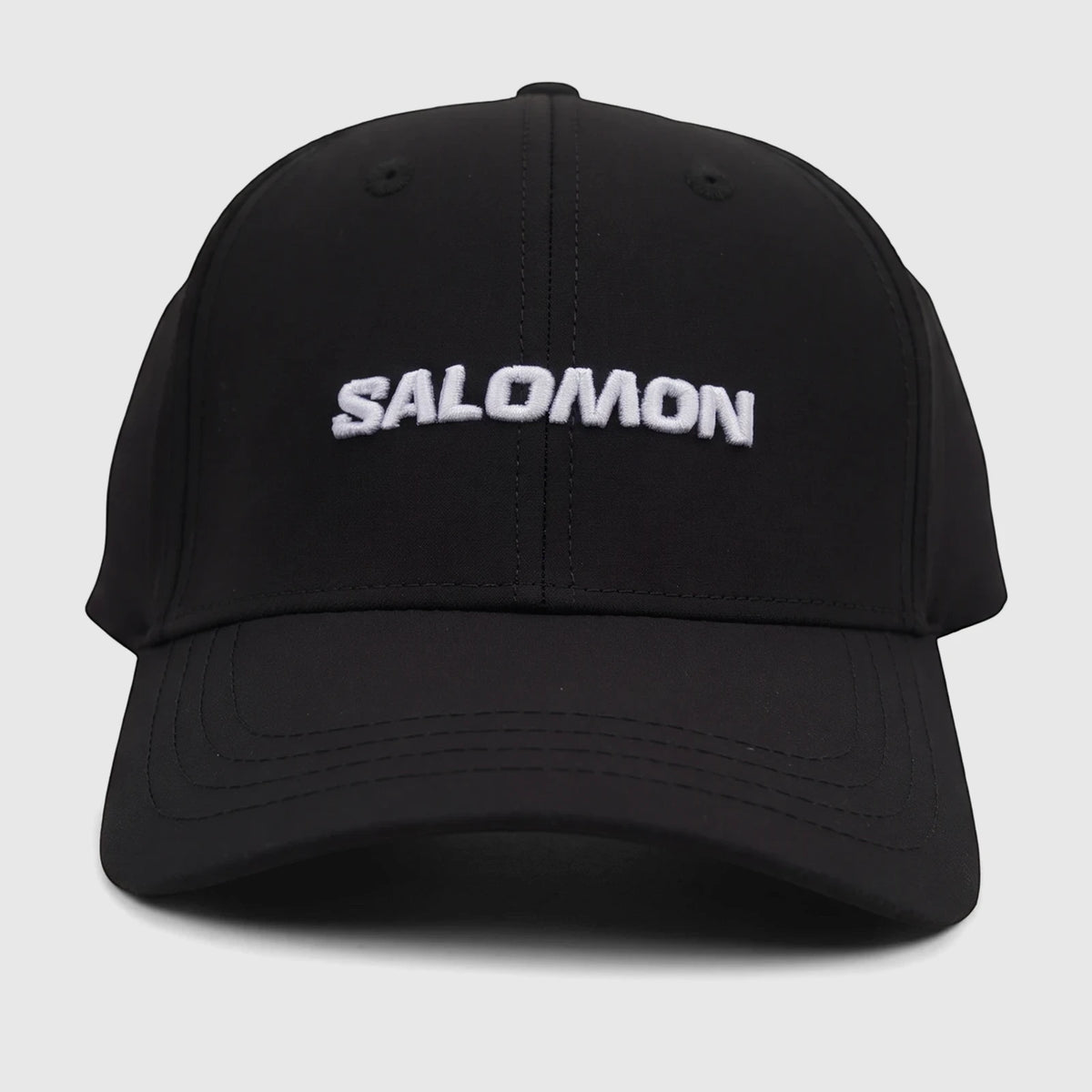 Front view of a black Salomon adjustable cap with the brand name 'SALOMON' embroidered in white across the front.
