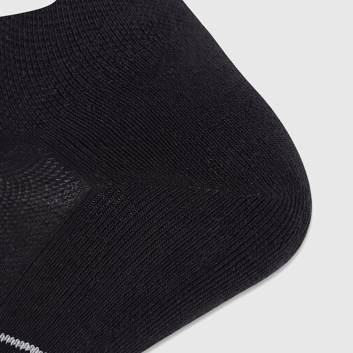 Close-up of a Salomon Men's SUO 0605 Xa Sonic Sock in Deep Black/Alloy, showing knit texture and toe area.