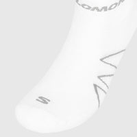 Close-up of a white Salomon Men's Sock with grey branding and chevron patterns, highlighting the knit texture.
