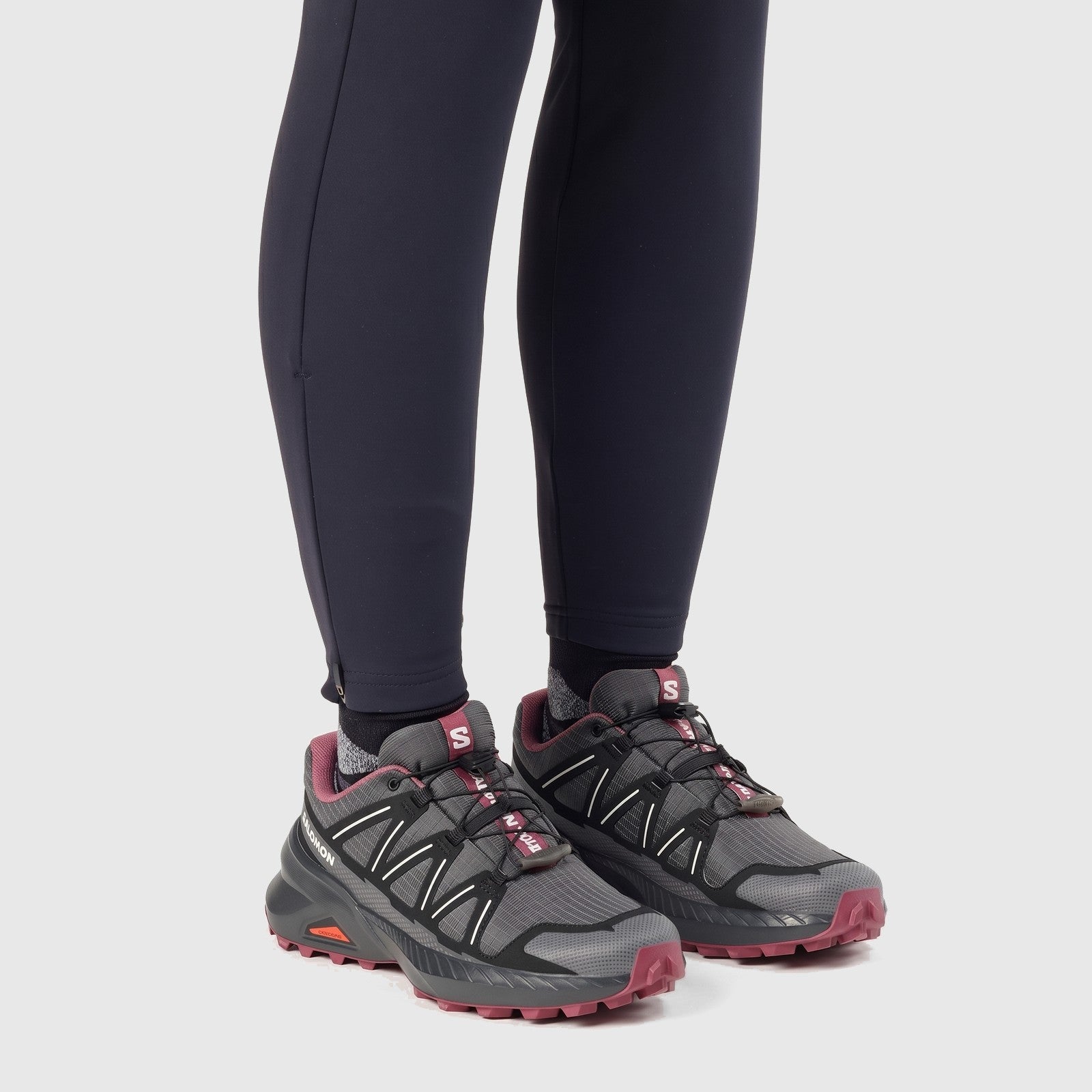 Salomon Speedcross Peak W ladies sneaker in asphalt and black mesh with pink accents, side view worn on feet.