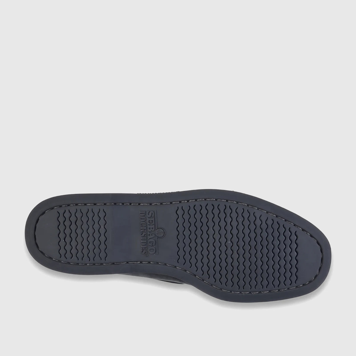 Underside view of a dark grey Sebago Men's Docksides Portland boat shoe, showing the sole with wavy traction pattern.
