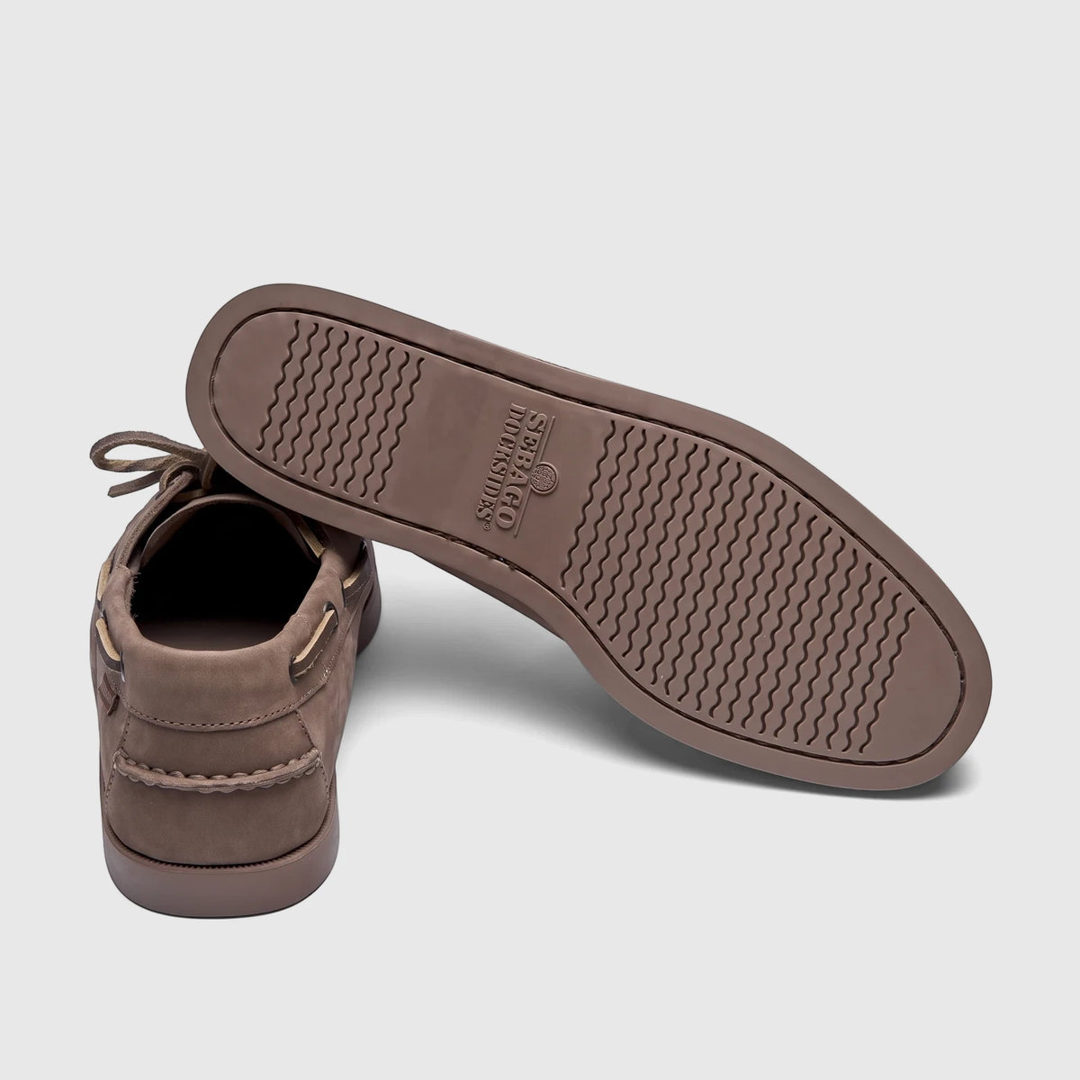 Pair of Sebago Men's Docksides Portland Nubuck boat shoes in total brown taupe, shown from a rear-angle view.