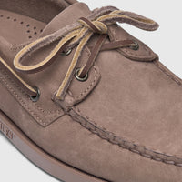 Close-up view of a men's brown nubuck Sebago Docksides Portland boat shoe with leather laces and visible stitching.