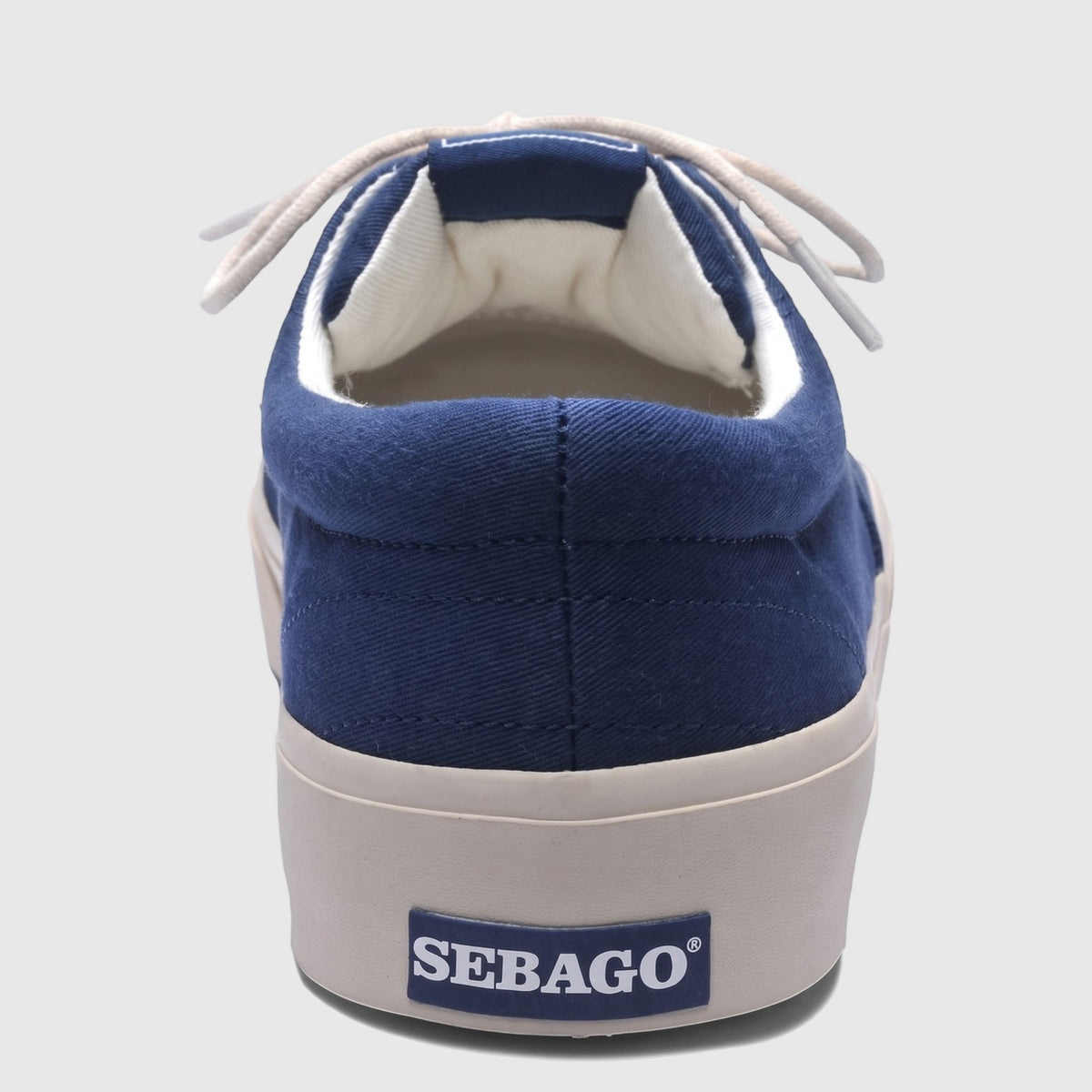 Rear view of a Sebago Men's Sneaker AL 75131SW 908 in blue navy canvas with white laces and an off-white sole.