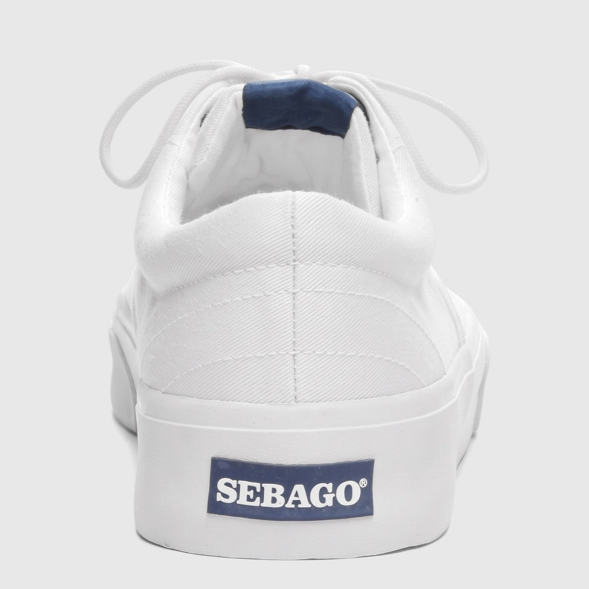 Rear view of a Sebago Men's AL 75131SW 911 white canvas sneaker with blue logo detail on the heel.
