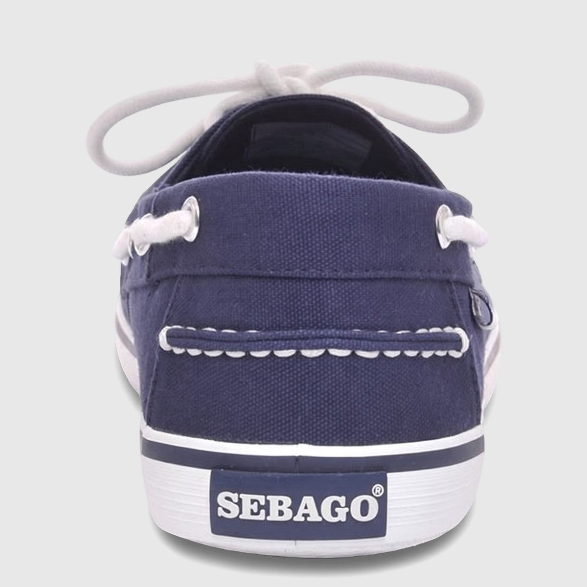 Rear view of a Sebago Pascal unisex boat shoe in navy blue canvas with white laces and a white rubber sole.