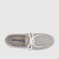 Overhead view of a single Sebago Unisex Boat Shoe in grey canvas with white laces and a blue sole stripe, against a white