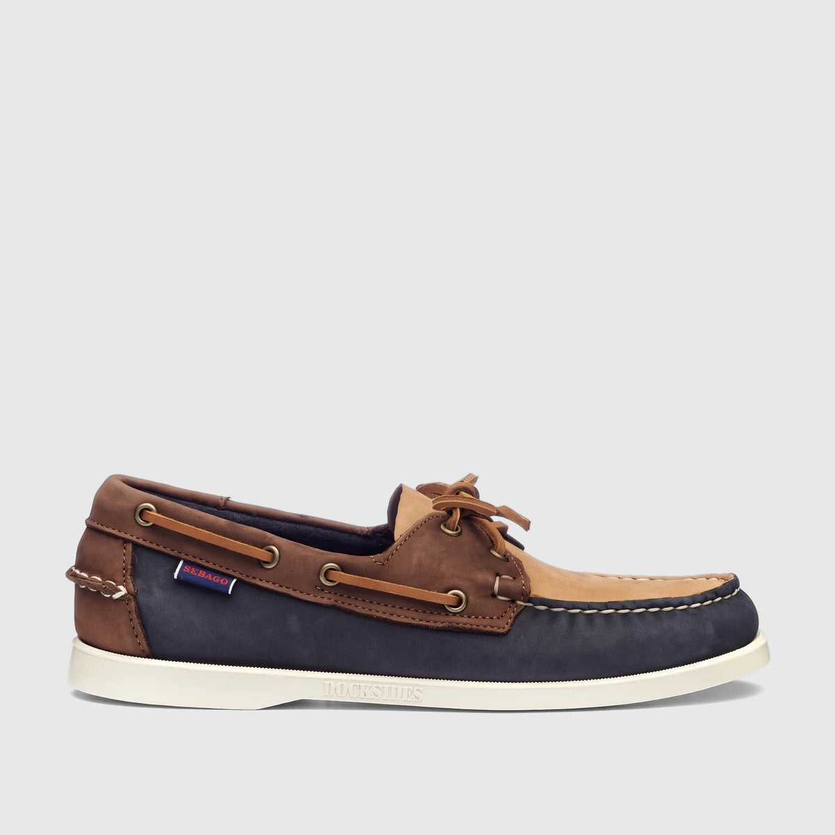 Sebago Women Portland Archive A53 boat shoe in navy, brown, and tan leather, presented in a side profile. Features classic