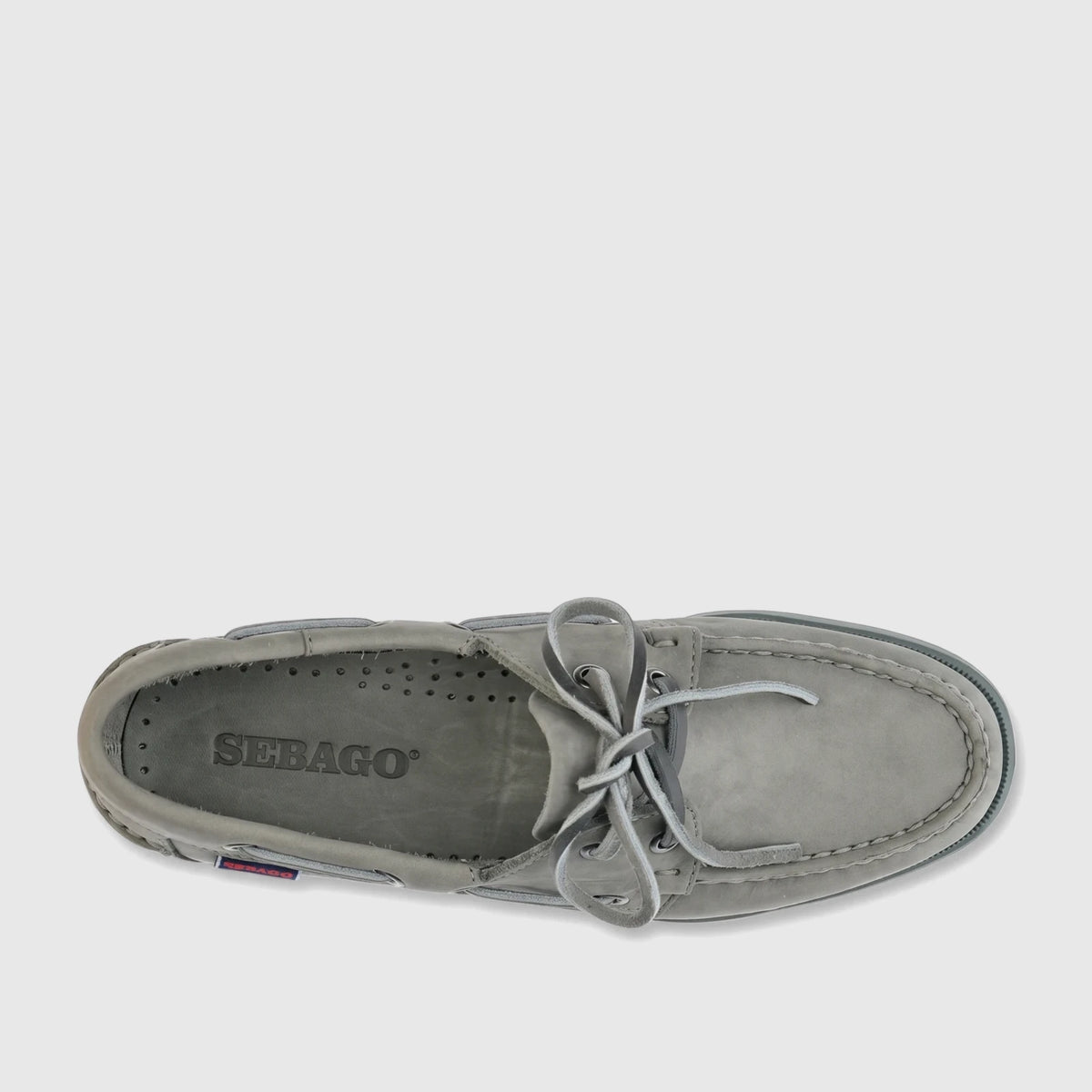 Overhead view of a single grey Sebago Women Portland Nubuck boat shoe with tied laces and prominent stitching details.