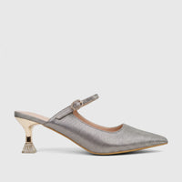 Silver glitter pointed toe mule with rhinestone buckle strap and embellished gold kitten heel for evening wear.