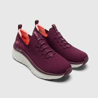 A pair of Skechers D'Lux Walker 149356 plum slip-on sneakers with a knitted upper and thick white soles, viewed from a