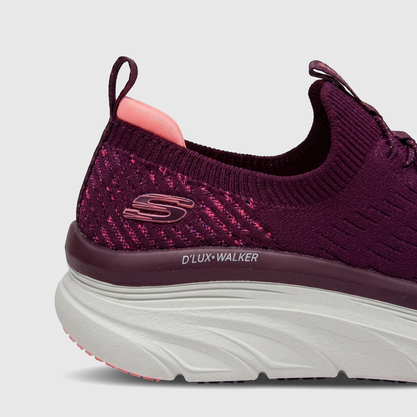 Skechers D'Lux Walker women's comfort slip-on sneakers in plum with a knit upper and chunky white sole, side view.