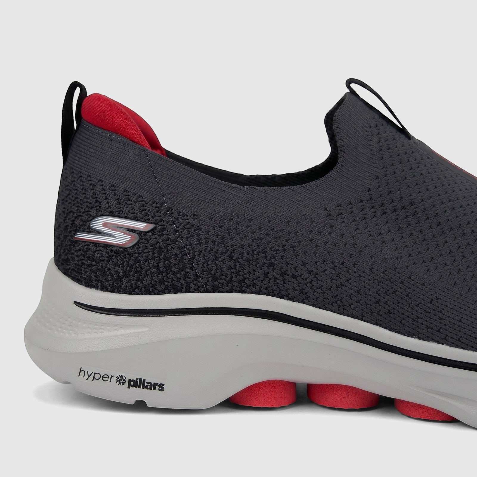 Skechers Go Walk 7 Men's Comfort Slip On Sneaker in charcoal black, showcasing knitted upper and cushioned sole from a side