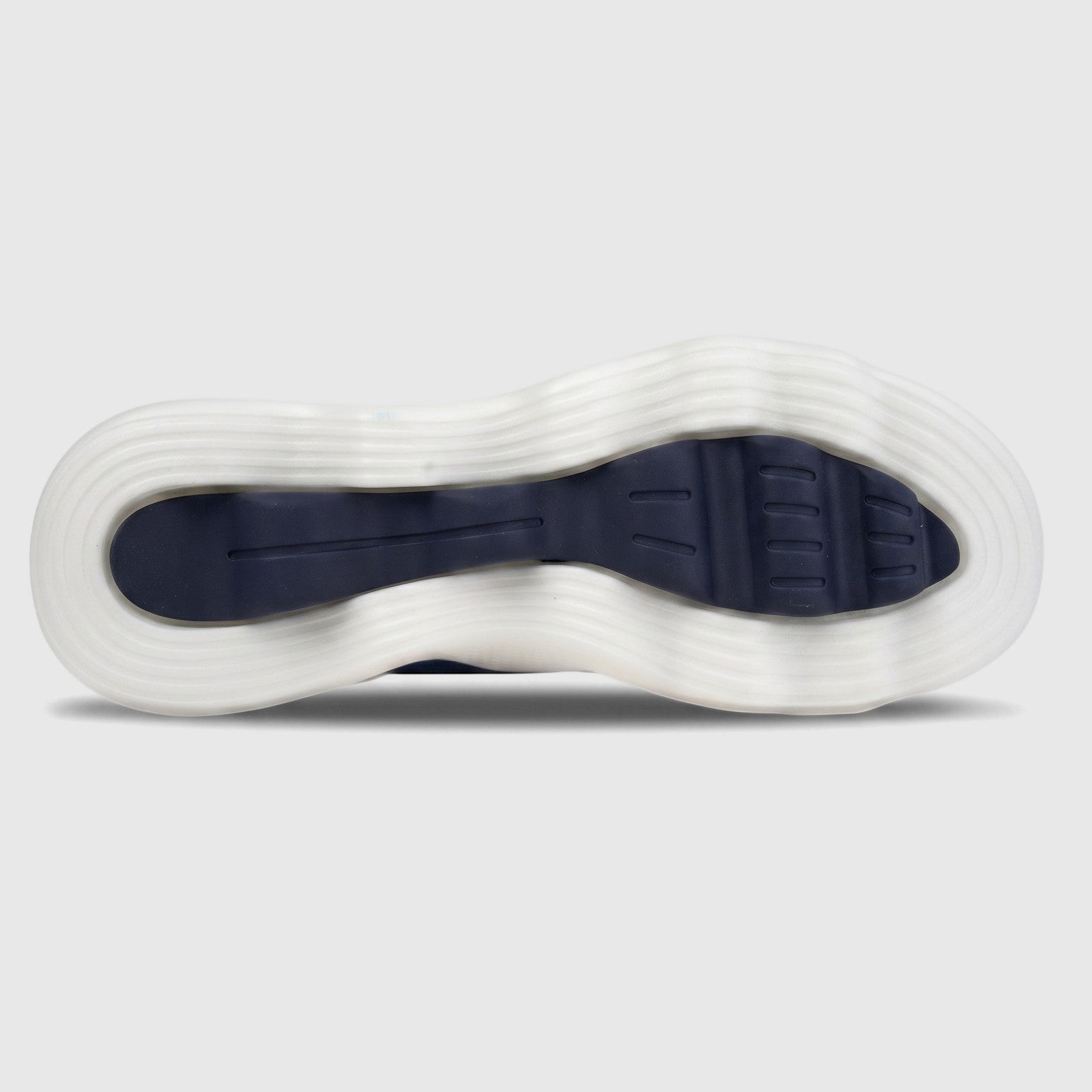 Underside view of a Skechers Go Walk Massage Fit sneaker, showcasing its navy blue sole tread and white wavy outsole.