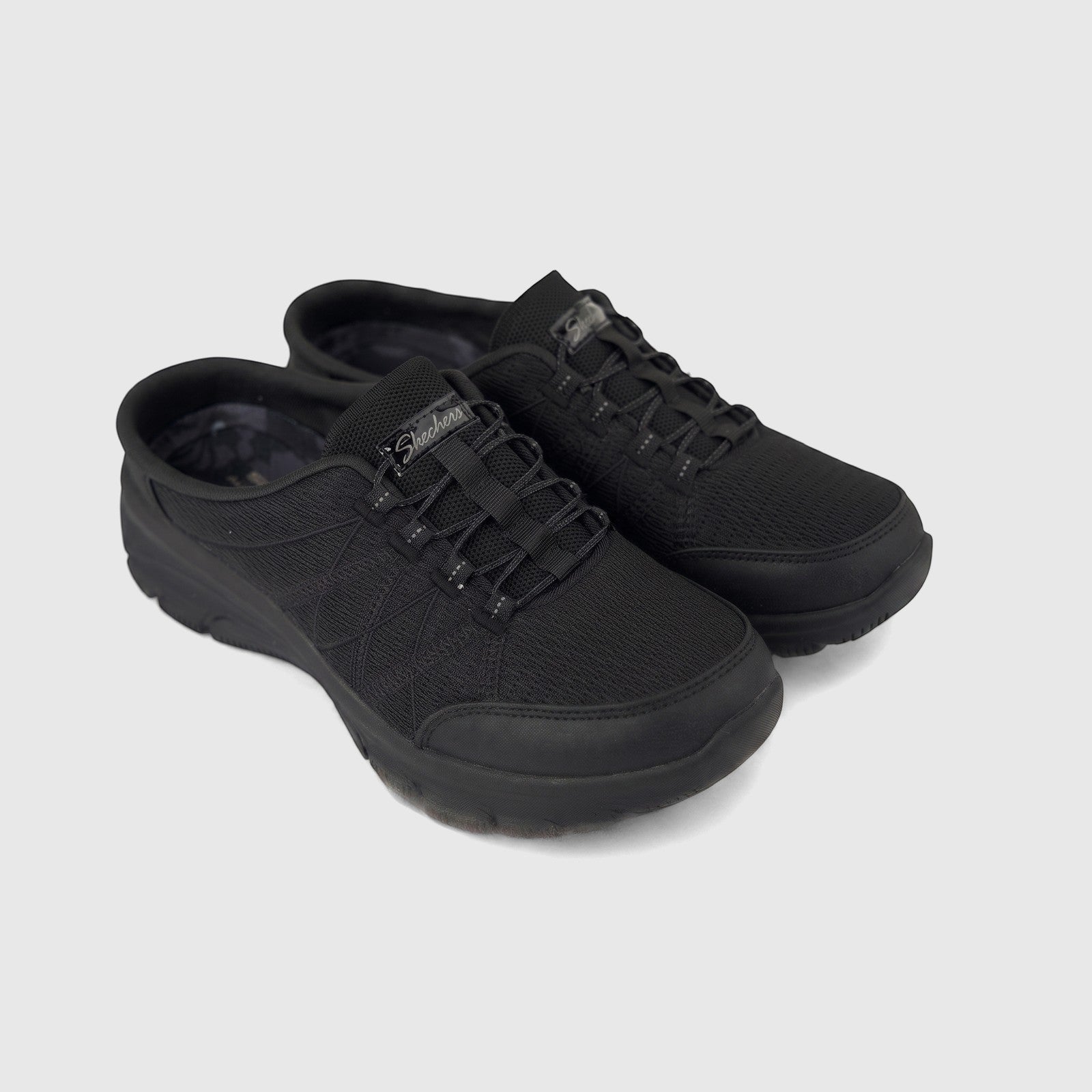 A pair of black Skechers Ladies Comfort Open Back Easy Going 100860 slip-on shoes with mesh uppers, viewed from a slightly