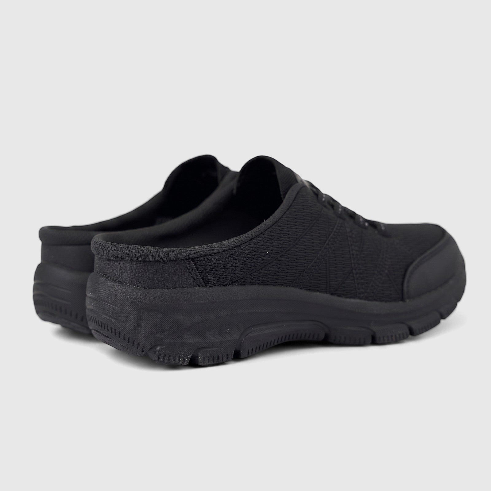 Black Skechers Ladies Comfort Open Back Easy Going slip-on shoes, designed for comfort, shown from a rear-side view.