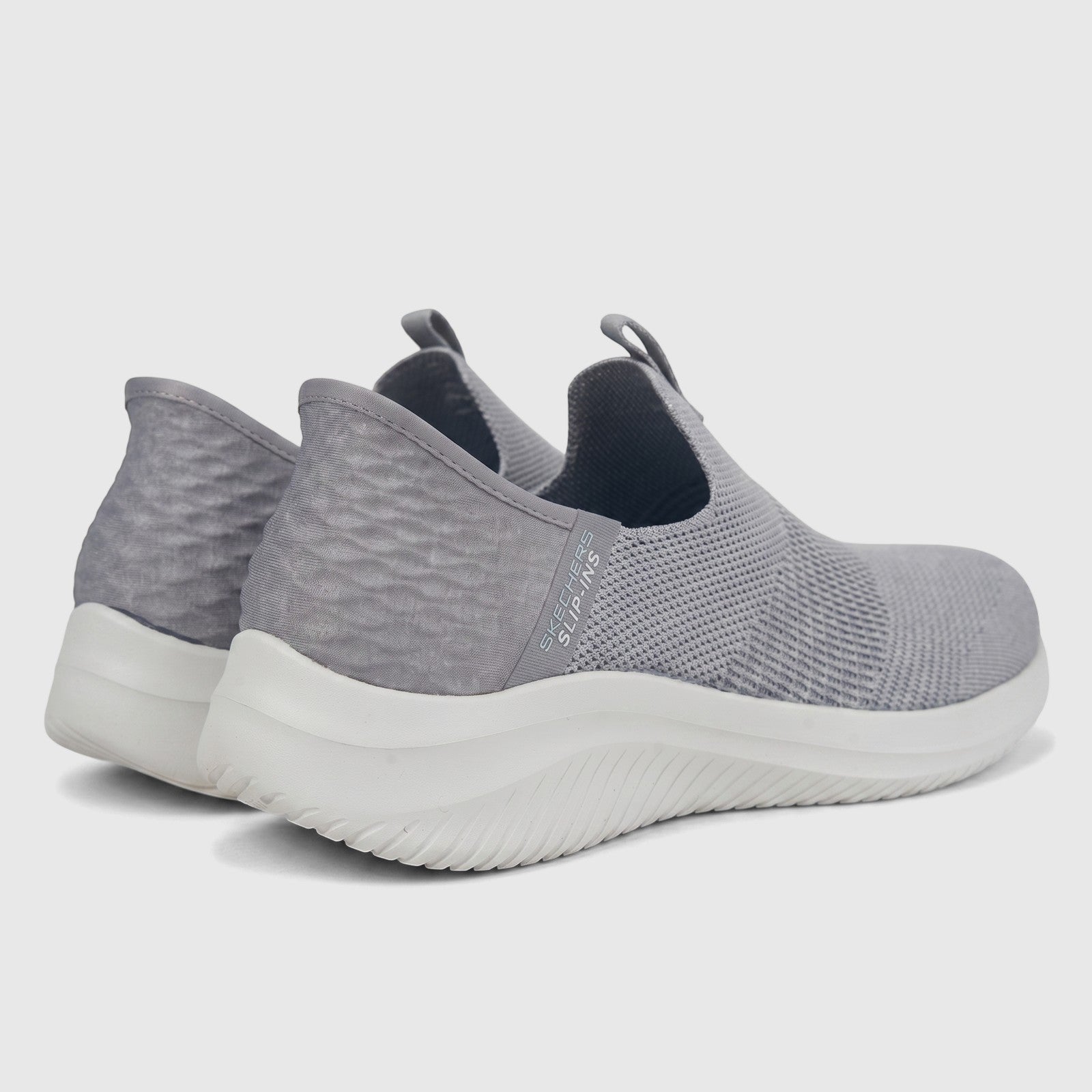 Pair of light grey Skechers Ladies Comfort Slip Ins Ultra Flex 3.0 sneakers, shown from a rear-side view.