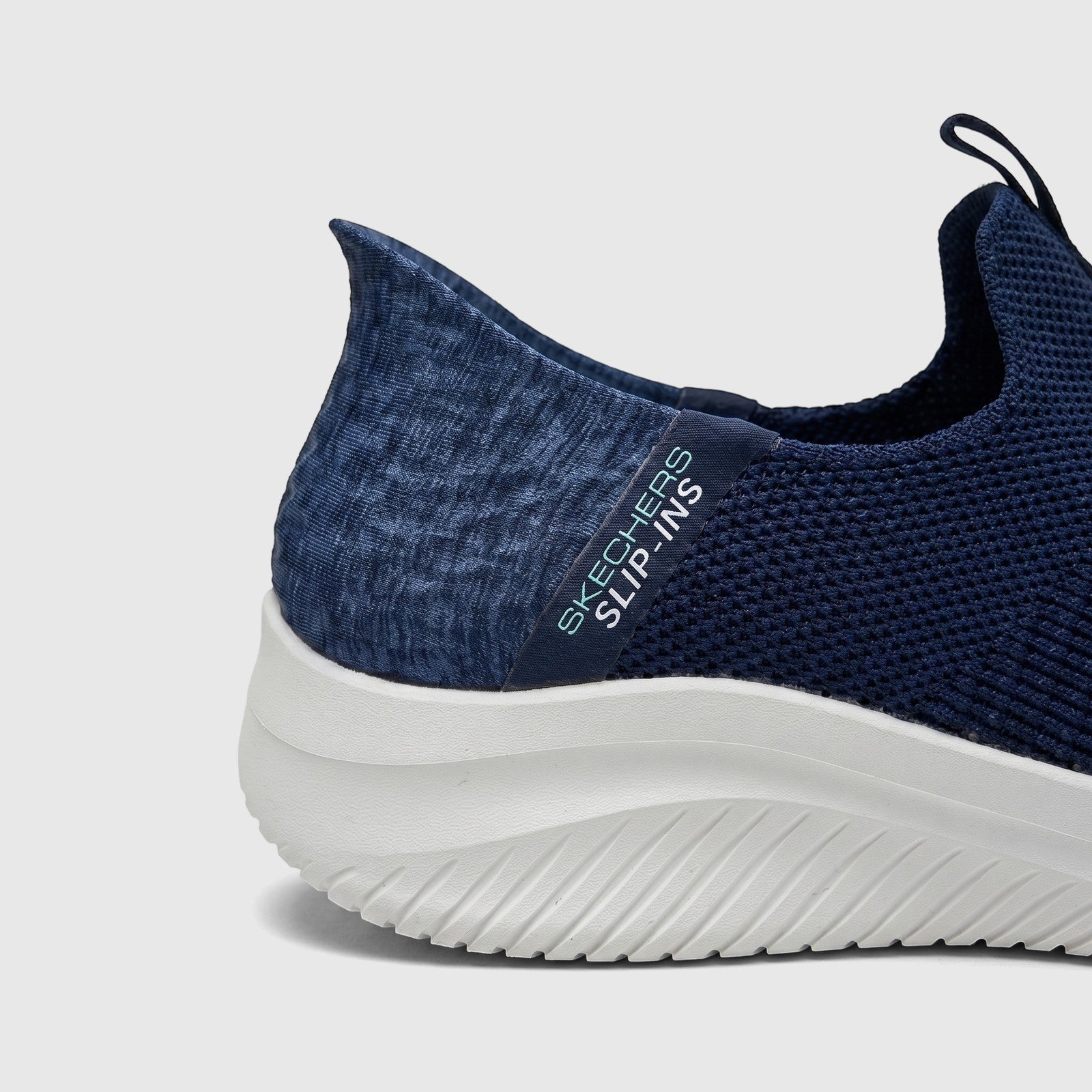 Close-up of a navy blue Skechers Ladies Comfort Slip-Ins Sneaker Ultra Flex 3.0, showing the knitted upper, white sole, and