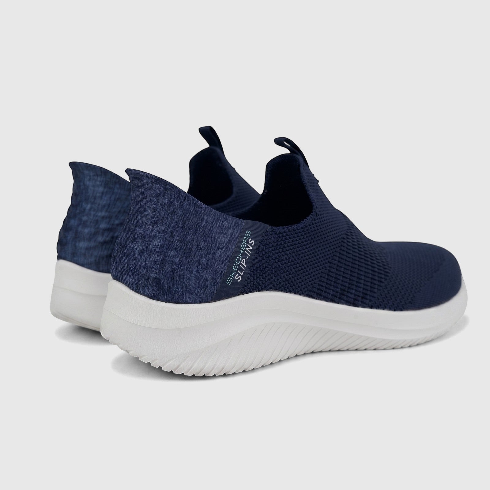 A pair of navy Skechers Ladies Comfort Slip-Ins sneakers, Ultra Flex 3.0 149709, with a white sole, viewed from a rear-side