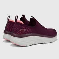 Skechers Ladies D'Lux Walker slip-on sneakers in plum knit fabric, shown from a rear angle with white soles.